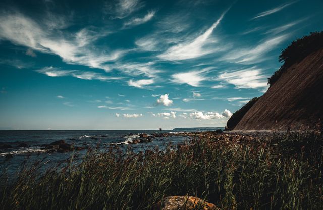 Beautiful view of the Baltic Sea coastline with dramatic cliffs and blue sky.